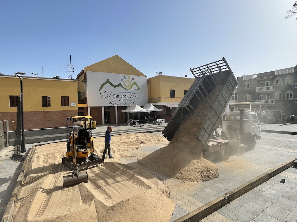 operarios trabajan en la colocación de la arena en la plaza